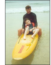 Jackson surfing Cronulla beach with Carl Vanzino
